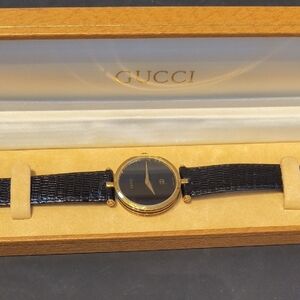 Gucci Black and Gold Timepiece